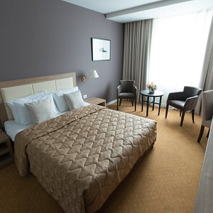 New City Hotel & Restaurant Niš in Nis, image may contain: Bed, Chair, Laptop, Lamp