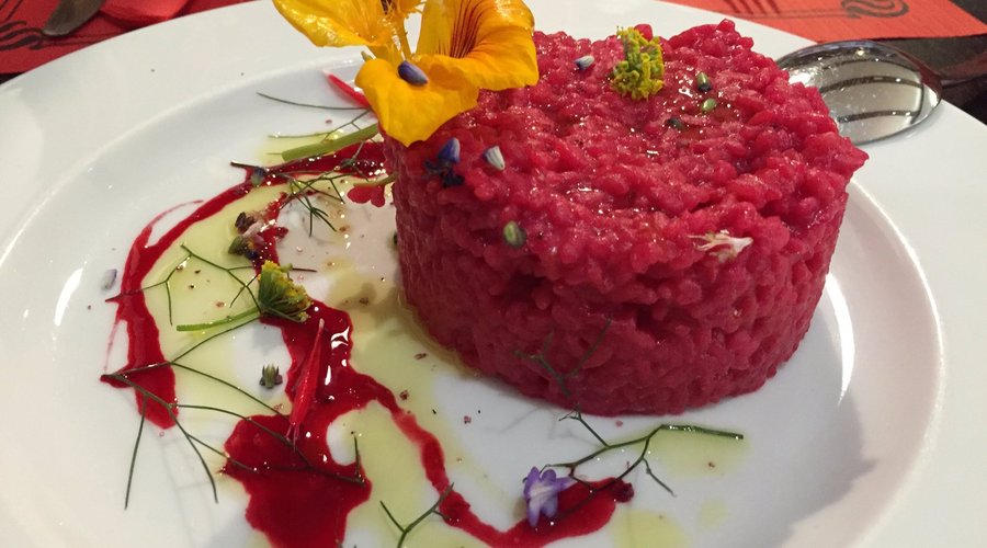 Risotto made coloured with cacti fruit and seasoned with basil seeds