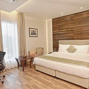 Hotel Connaught Royale in New Delhi, image may contain: Interior Design, Indoors, Wood, Bed
