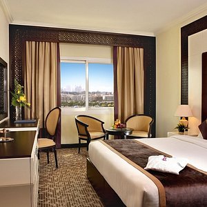 Carlton Tower Hotel Dubai in Dubai, image may contain: Hotel, Chair, Furniture, Bed