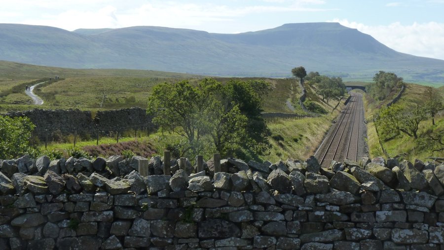 Aqueduct is between walls, access track seen on left,ingleborough behind