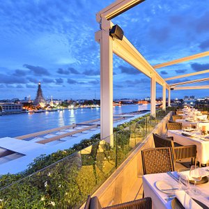 Above Riva, rooftop restaurant - view of Wat Arun & Chao Phraya River with removable roof open