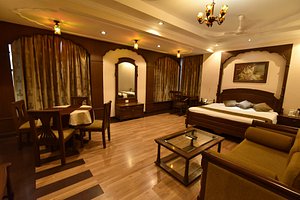 Hotel Niky International in Jodhpur, image may contain: Flooring, Chandelier, Lighting, Bed