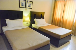 Hotel Tavern in Mindanao, image may contain: Lamp, Bed, Furniture, Bedroom