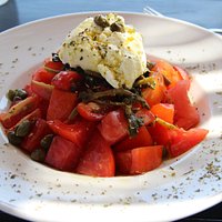 Tomato salad with local sour cheese, capers and purslane