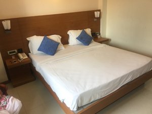 Moskva Hotel in Madurai, image may contain: Furniture, Bed, Person, Bedroom