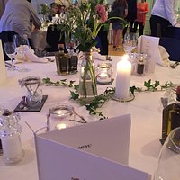 Tables prepared for a birthday dinner with about forty guests