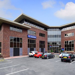 Travelodge Manchester Sale in Sale, image may contain: Office Building, Car Dealership, Car, Neighborhood