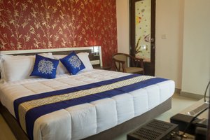 Hotel Landmark in Bhubaneswar, image may contain: Furniture, Bed, Chair, Bedroom
