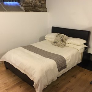 Hypnos bed with pillowed mattress topper