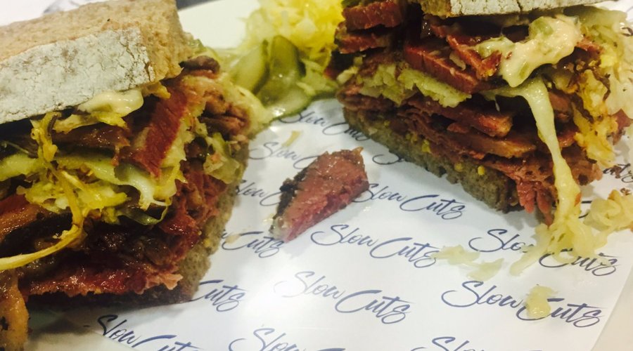 House cured pastrami sandwich on rye with swiss cheese and home made sauerkraut
