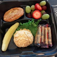 Scoop of chicken salad, fresh fruit, and a fresh baked cookie to go