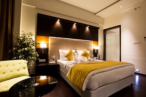 WE Hotels in Pimpri-Chinchwad, image may contain: Interior Design, Furniture, Home Decor, Cushion
