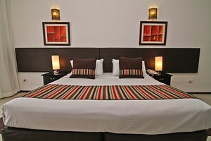 De La Plaza Hotel in Maldonado, image may contain: Furniture, Home Decor, Cushion, Bed