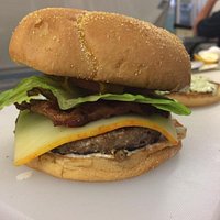 Ground Sirloin Steak Burger with Muenster cheese served on a toasted Kaiser roll.