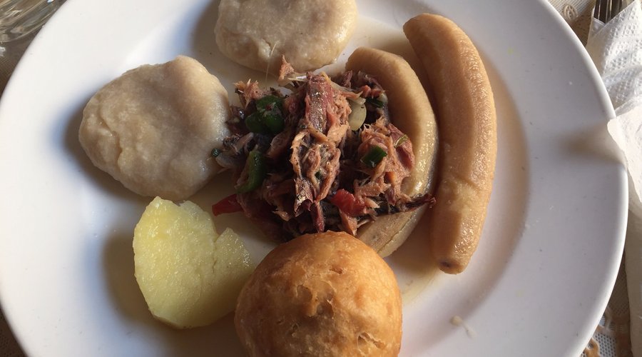 Mackeral with peppers and onions, boiled and fried dumplings, boiled banana, and yams