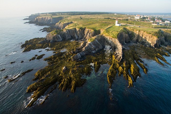 Aerial view of Cape Saint Mary Lighthouse and cliffscape.