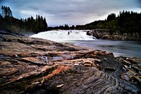 Laksforsen cascade in Grane municipality in Nordland Province in Norway  running over some 17 meter high cascades over a rocky stretch Stock Photo -  Alamy