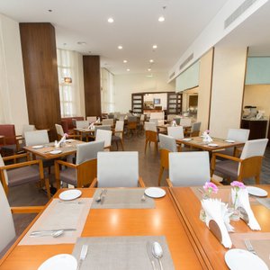 Lavender Hotel Deira in Dubai, image may contain: Dining Room, Dining Table, Restaurant, Cafeteria