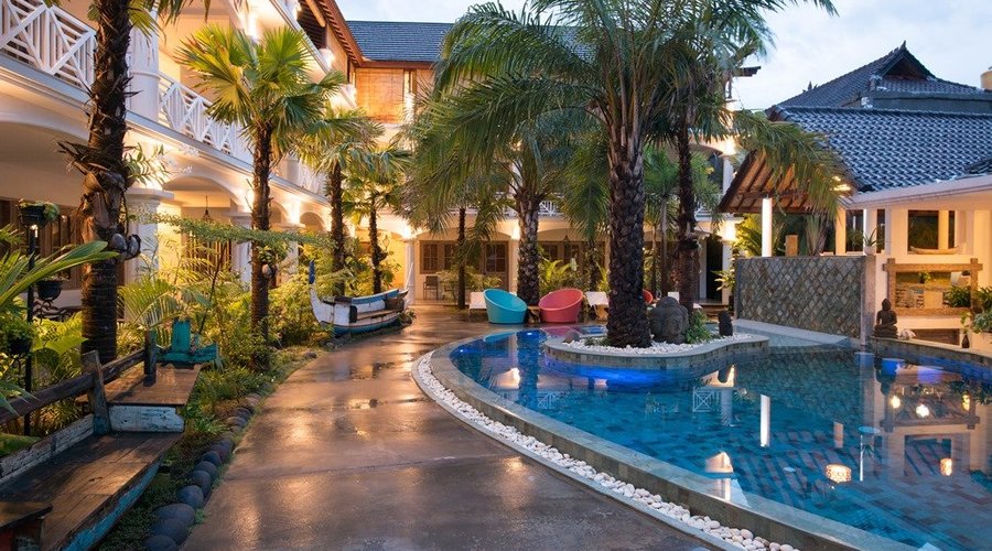 Hotel atrium with relaxing area and sun chairs