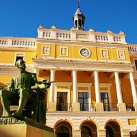 Estatua de Luis de Morales en primer plano. El ayuntamiento se encuentra a sus espaldas.