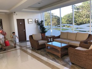 The Reef Hotel and Residences in Luzon, image may contain: Living Room, Handbag, Floor, Person