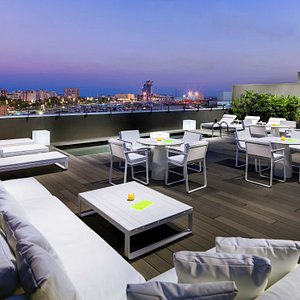 H10 Port Vell in Barcelona, image may contain: Terrace, Table, Dining Table, Chair