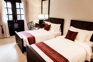 99 The Heritage Hotel in Chiang Mai, image may contain: Bed, Furniture, Chair, Bedroom