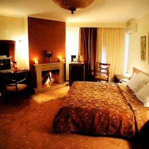 Nostos Hotel in Kastoria, image may contain: Fireplace, Indoors, Home Decor, Furniture