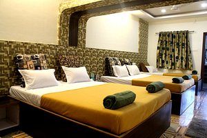 Hotel Malhar Palace in Shirdi, image may contain: Resort, Hotel, Building, Bed