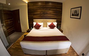 Hotel Connaught Royale in New Delhi, image may contain: Interior Design, Indoors, Wood, Bed