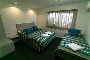 Top Spot Motel in Maroochydore, image may contain: Bed, Furniture, Bedroom, Indoors