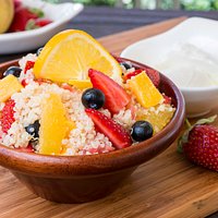 Quinoa alla frutta with strawberries, blueberries, papaya, orange and yogurt dressing.