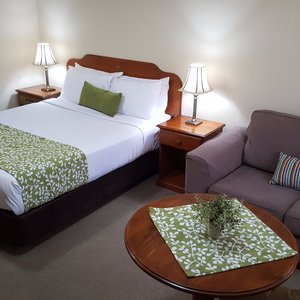 Ballina Heritage Inn in Ballina, image may contain: Couch, Furniture, Lamp, Bed