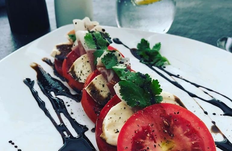 Mozzarella and Parma ham salad, basil pesto and chili oil 