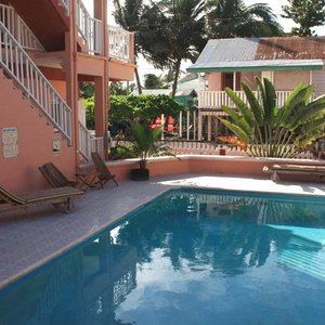 Caye Caulker Condos in Caye Caulker, image may contain: Balcony, Building, Chair, Furniture