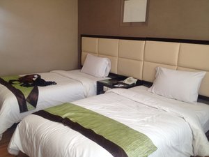Maqna Hotel in Gorontalo, image may contain: Furniture, Bedroom, Bed, Indoors