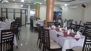 Midtown Hotel in Rawalpindi, image may contain: Restaurant, Dining Table, Table, Dining Room