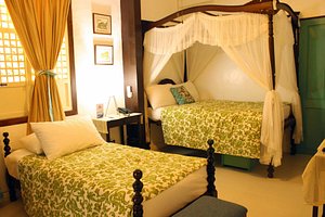 Paradores Del Castillo in Luzon, image may contain: Furniture, Bedroom, Indoors, Bed