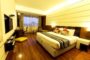 Hotel GK International in Chandigarh, image may contain: Interior Design, Screen, Monitor, Chair