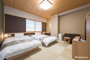 Natural Hot Springs Toyama Tsurugi no Yu Onyado Nono in Toyama, image may contain: Interior Design, Dorm Room, Bed, Bench
