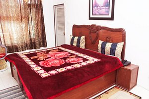 Hotel Victoriya Palace in Dharamsala, image may contain: Home Decor, Furniture, Bed, Cushion