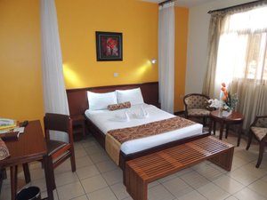 Hennessis Hotel in Nairobi, image may contain: Chair, Hotel, Bench, Bed