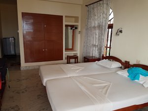 Aparna Guest House in Kovalam, image may contain: Bed, Furniture, Lamp, Bedroom