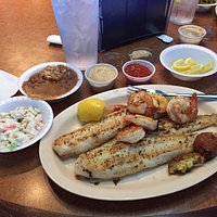 Grilled catfish with grilled shrimp. Sides of cole slaw, red beans & rice w/ a couple of hushpup