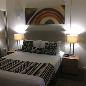 Central Cosmo Apartments in Brisbane, image may contain: Lamp, Table Lamp, Bed, Cushion