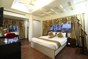 Hotel The Nagpur Ashok in Nagpur, image may contain: Bed, Furniture, Home Decor, Ceiling Fan