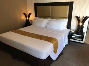 Mallberry Suites Business Hotel in Mindanao, image may contain: Furniture, Bed, Cushion, Home Decor