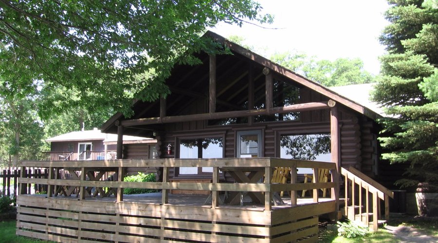 Cedars log home exterior.  Watch the family in the pool or in the lake from your deck.