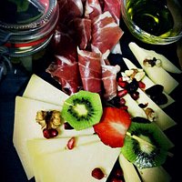 Excellent Aperol Spritz and combination of prosciutto, cheese, strawberries, kiwi and nuts that